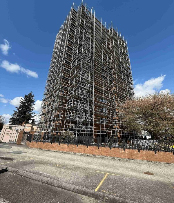 Reliable Scaffolding scaffold systems installed around a high-rise residential building for exterior restoration and construction access